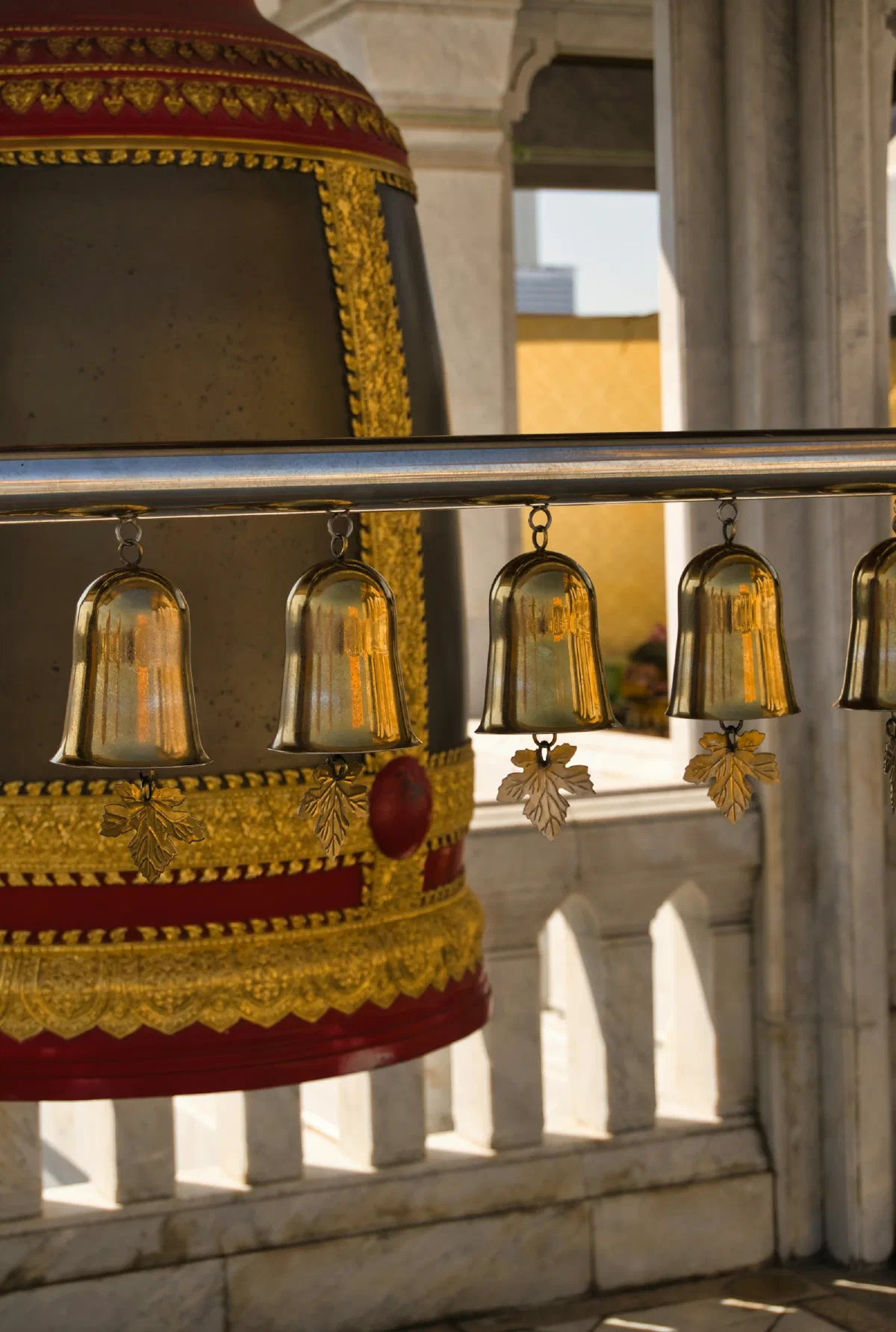 A row of hanging brass temple lamps