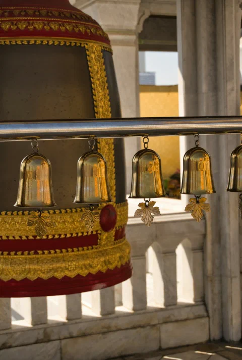 A row of hanging brass temple lamps