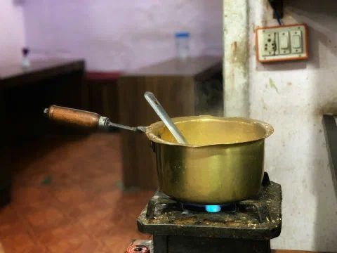 A brass pot on a stove in a traditional kitchen