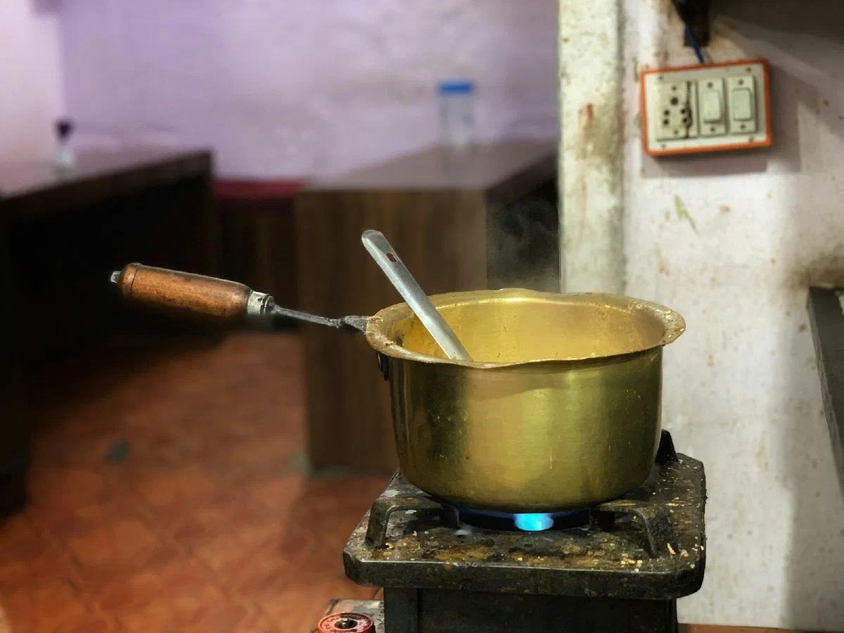 A brass pot on a stove in a traditional kitchen