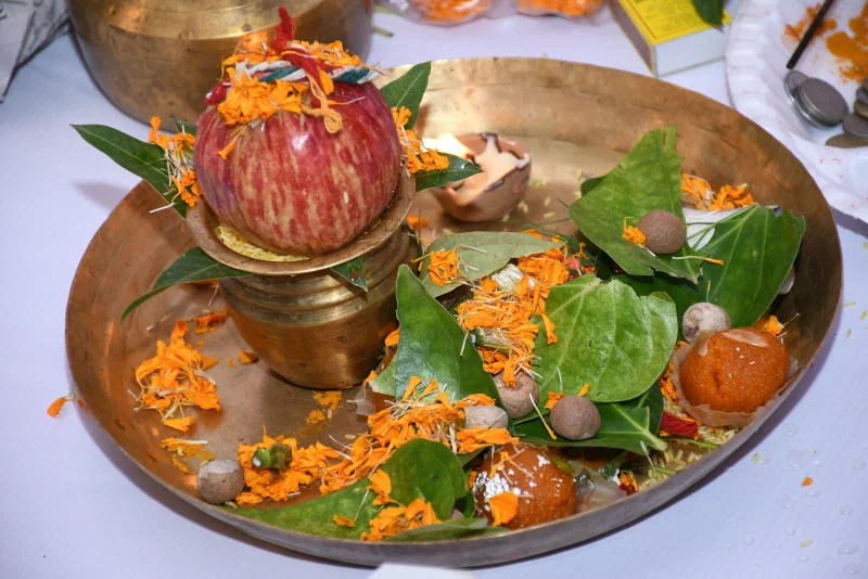 A brass kalash with flowers
