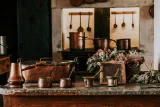 A shelf of well-used brass vessels