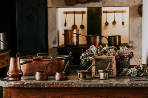 A shelf of well-used brass vessels