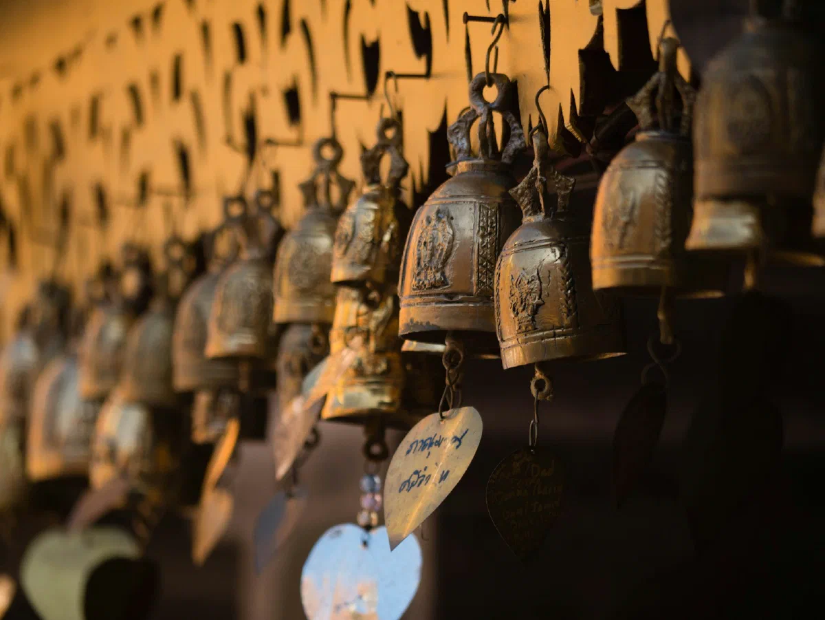 Brass temple bells hanging in a row
