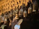 Brass temple bells hanging in a row
