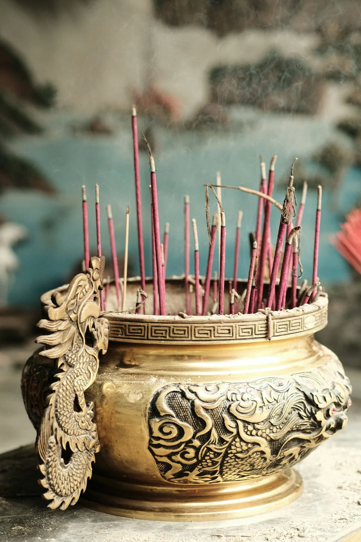 Incense sticks burning in an ornate brass holder