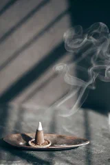 Incense smoke drifting across a window